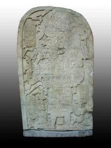 Photo of Machaquilá Stela 2, provided by and used with the permission of MUNAE; the cuts made by looters to render the sculpture into transportable blocks are visible.